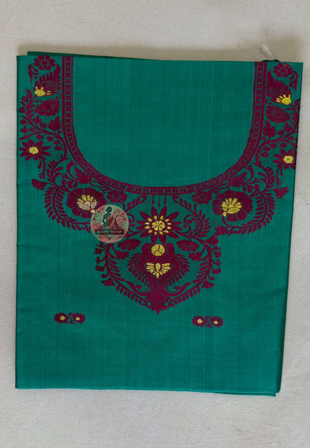 Detail shot of Baluchari woven motifs on green Mulberry silk kurti fabric – artisan handloom craft from West Bengal India