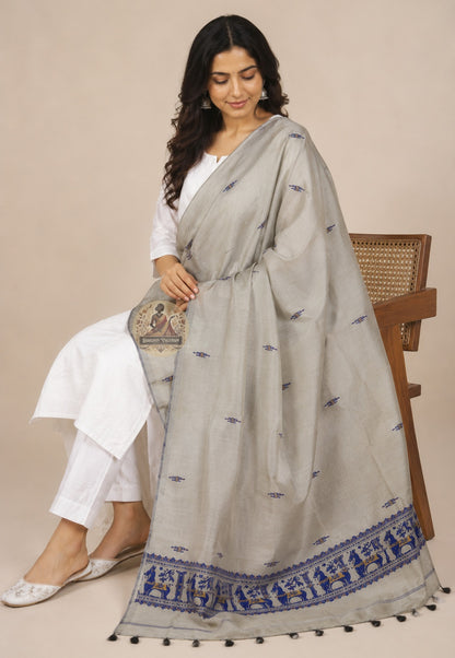 Seated drape view of handwoven Baluchari silk stole in stone grey – royal blue narrative border with woven court figures flowing to floor, perfect for Puja and festive occasions
