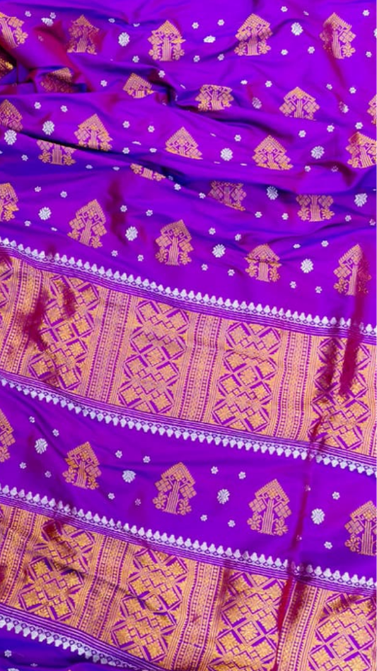 Front view of Assam Mulberry Silk Saree with copper zari draped on model, showcasing the warm metallic weave and fluid silk drape with rich earthy luminosity