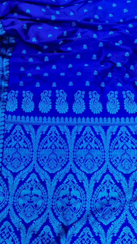 Front view of Assam Mulberry Silk Saree with hand thread work draped on model, showcasing the rich silk sheen and traditional woven motifs from Northeast India