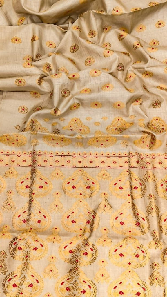 Indian woman in elegant Pure Muga Silk Saree at a wedding – available with UK delivery from Dakshin Vastram