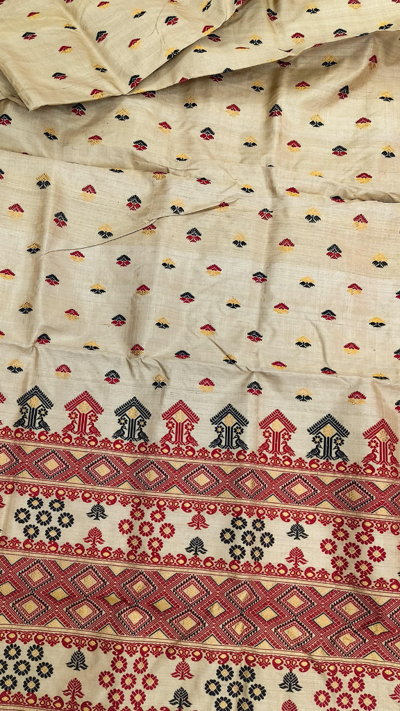 Side view of heirloom handloom Muga silk saree from Assam showing naturally golden silk drape with quiet authority, Antheraea assamensis silk that grows more lustrous with every year of wear