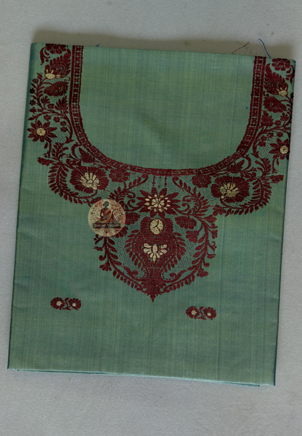 Detail shot of Baluchari narrative woven motifs on Pesta Green Mulberry silk kurti fabric – artisan handloom craft West Bengal India