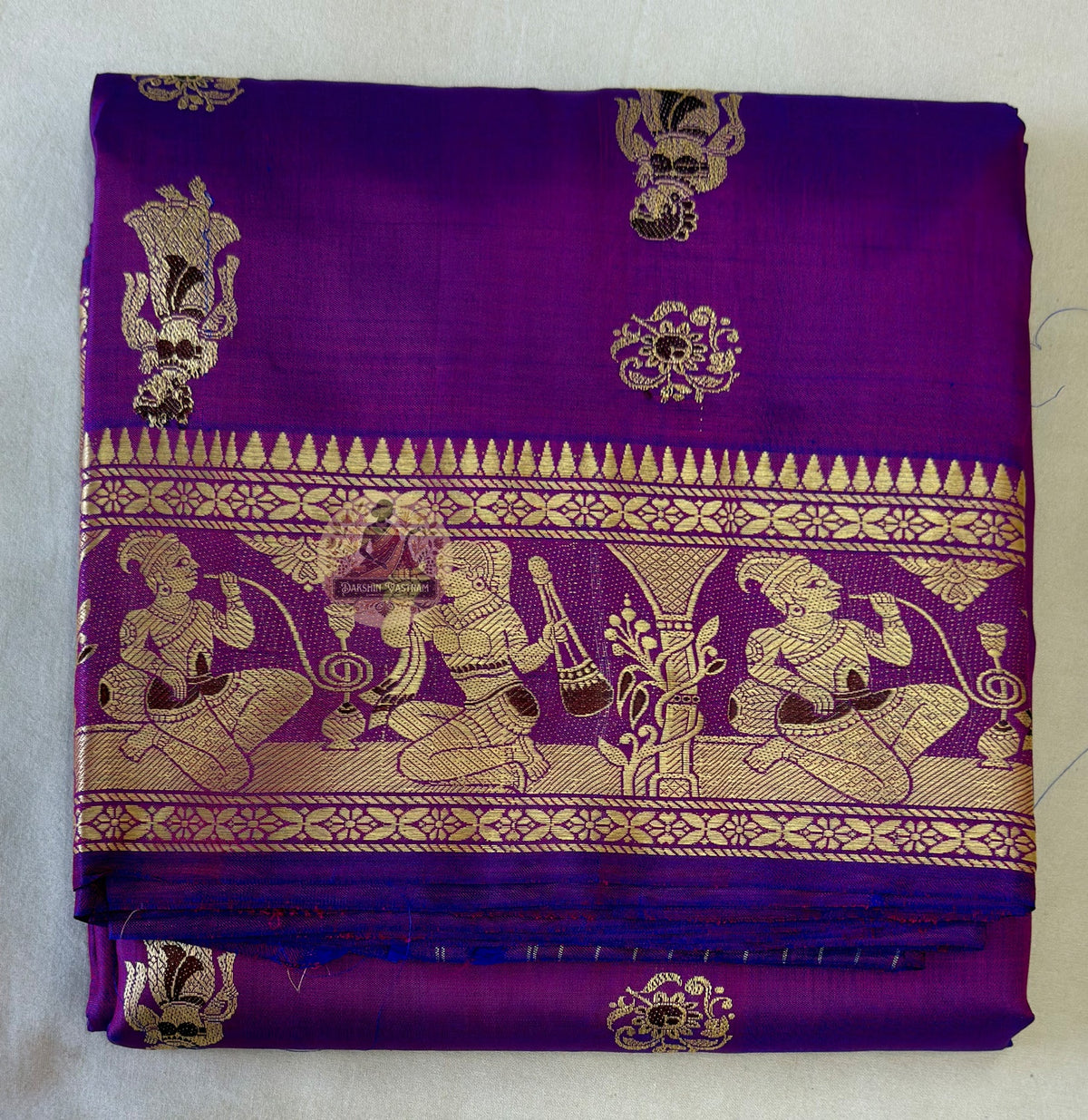 Traditional handloom Baluchari saree in fawn beige with hand-woven narrative motifs and burgundy contrast pallu