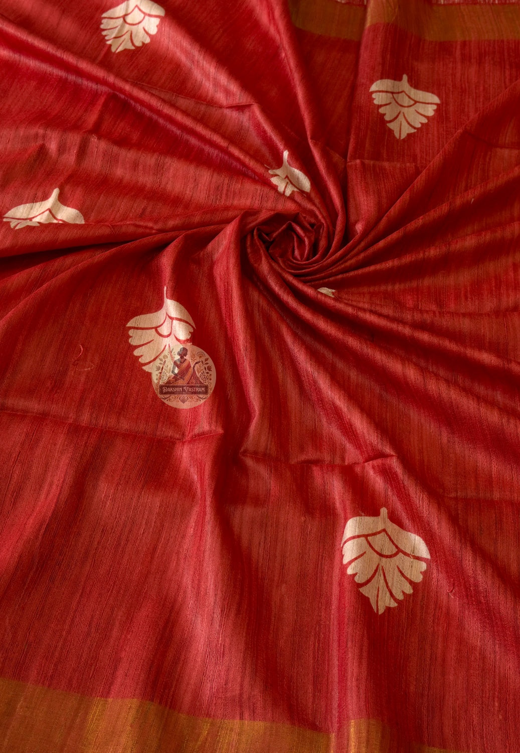 Close-up of Ghicha Tussar Silk weave revealing natural slubs, earthy golden tone and handloom craftsmanship — a timeless heirloom for Indian festive occasions