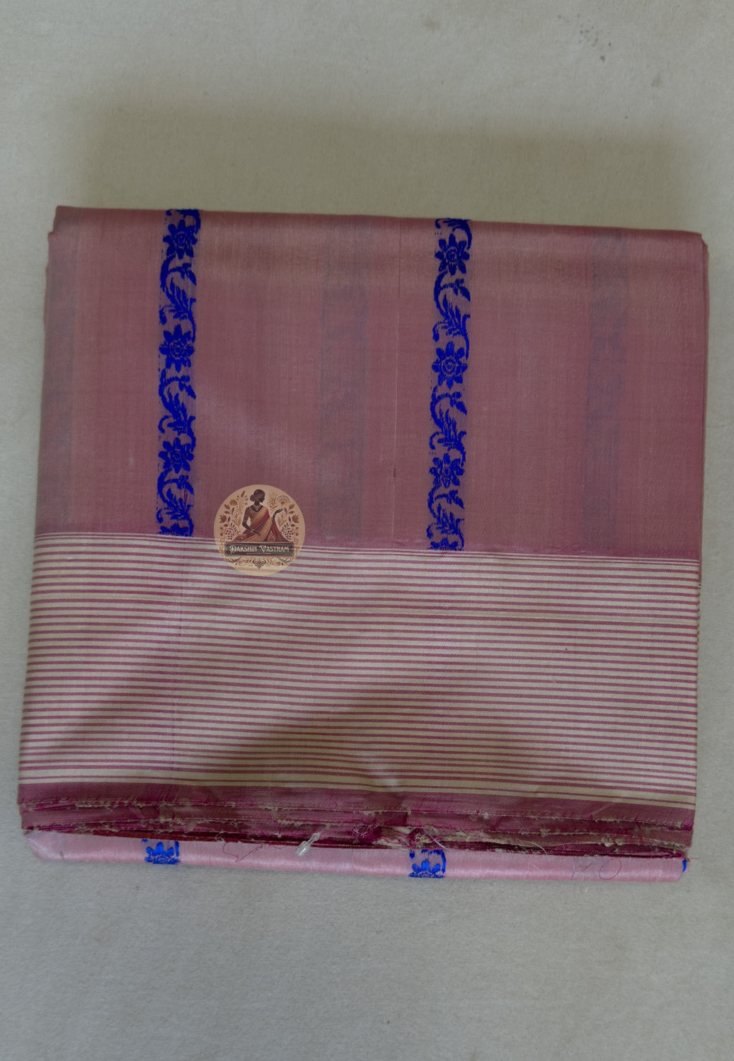 Full flat lay of handwoven Tussar silk saree from Jharkhand showing natural earthy gold body, tribal-inspired border and wild silk texture — Dakshin Vastram