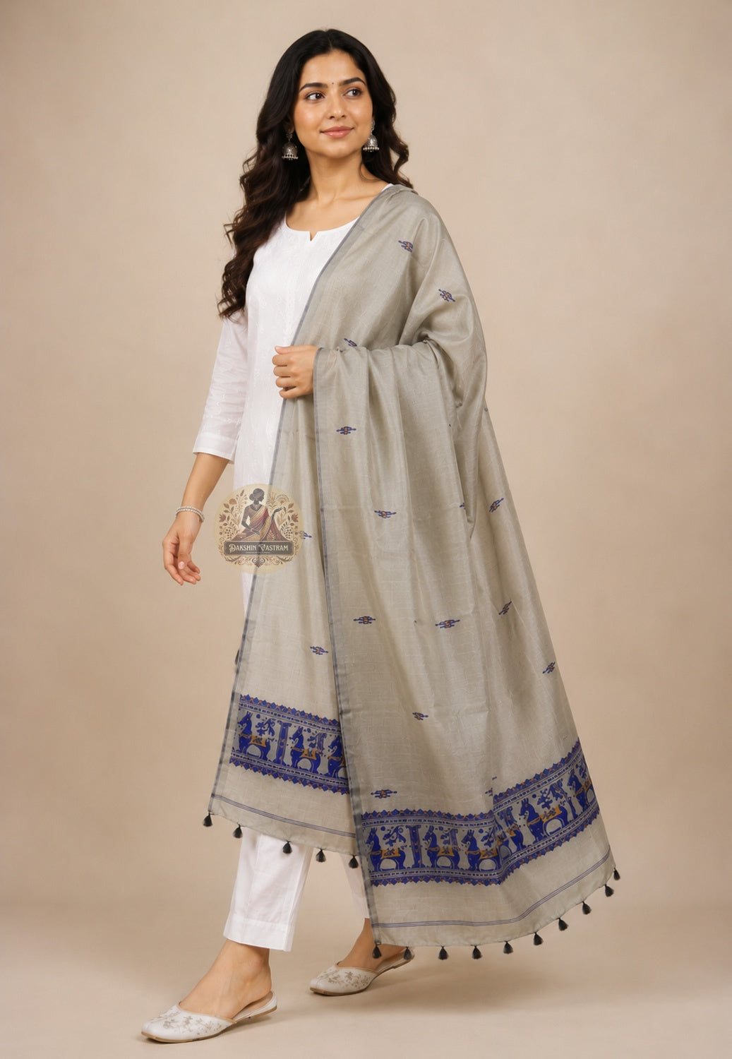 Front view of handwoven Baluchari silk stole in stone grey – pure silk with royal blue narrative border and black tassels draped over white kurta – Dakshin Vastram