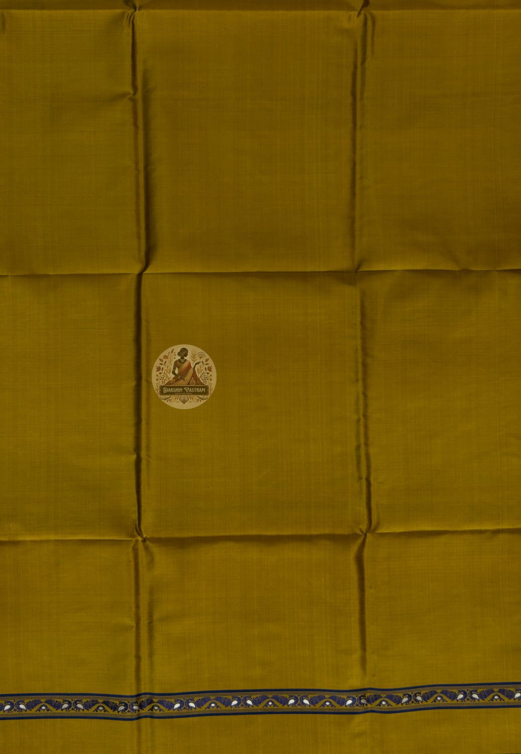 Detail shot of woven Baluchari border motifs on mustard yellow silk kurti fabric — artisan handcrafted textile from Bishnupur
