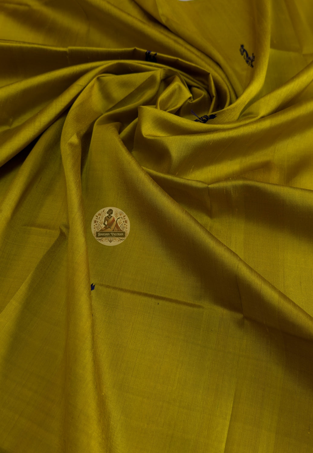 Border detail of handwoven Baluchari silk stole – intricate indigo blue mythological figures woven on turmeric yellow pure silk, traditional Bengal handloom craft