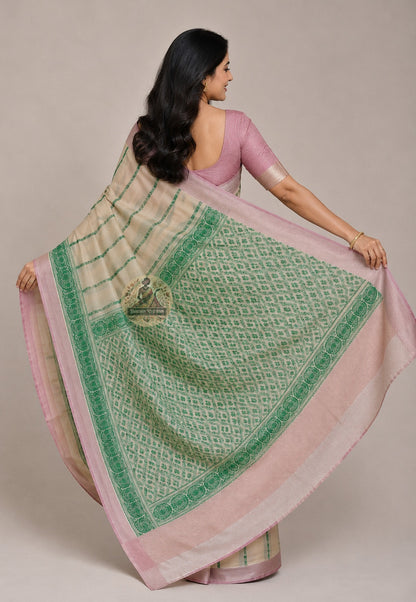 Woven-in paisley and lotus border on authentic Jharkhand Tussar silk saree — traditional motif integral to the fabric, autumn gold on natural wild silk base, Dakshin Vastram