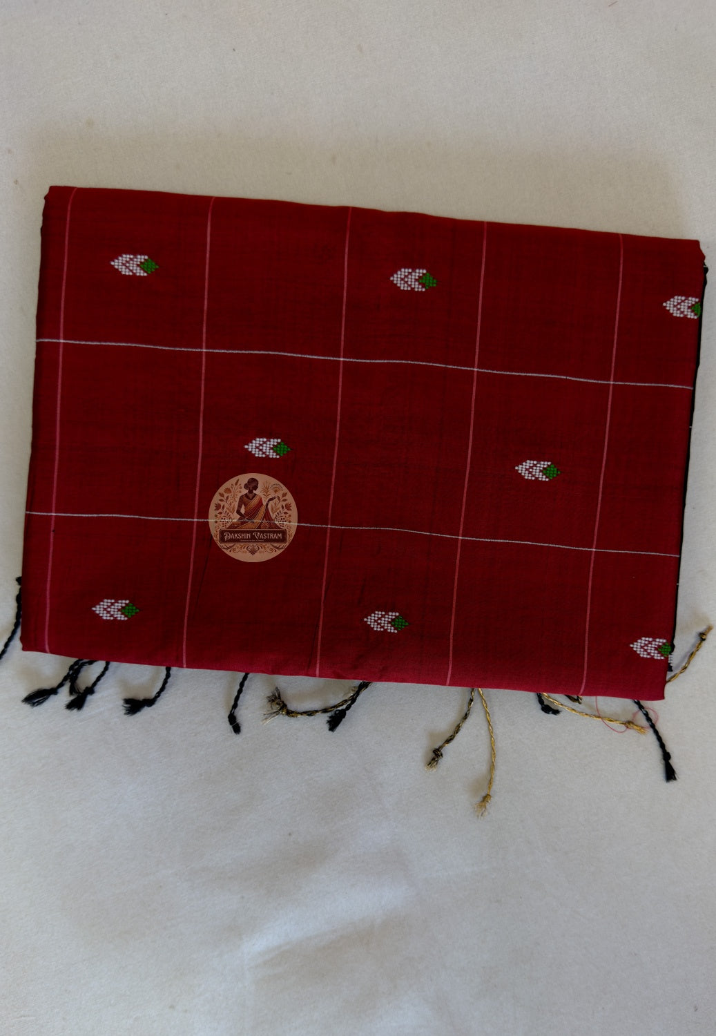Folded Bishnupuri handwoven pure katan silk saree – showcasing rich silk lustre and woven border, ethically sourced from Bengal artisans by Dakshin Vastram
