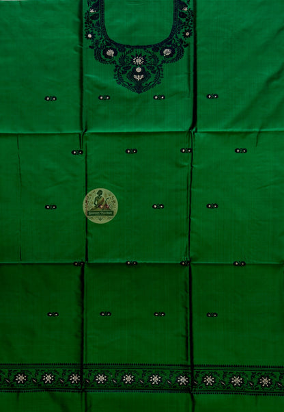 Flat lay of unstitched Baluchari silk kurti fabric in forest green showing full length and resham border pattern