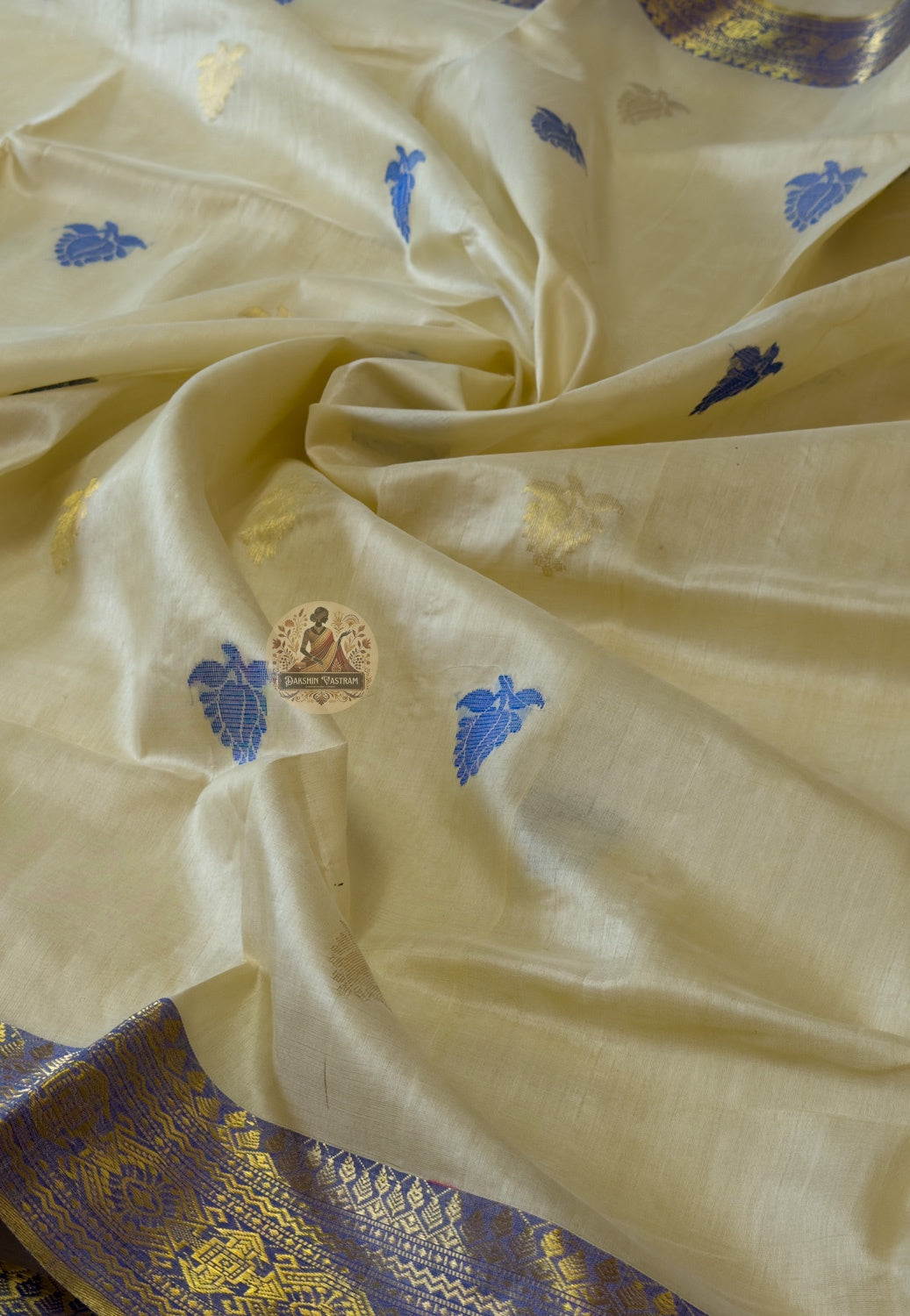 Flat lay of handwoven Tussar silk slub saree from Jharkhand showing natural earthy gold body, traditional border and wild silk texture detail — Dakshin Vastram